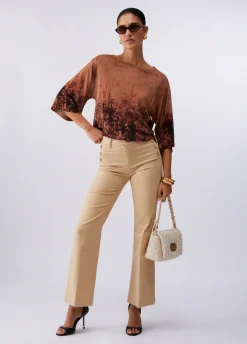 Pantaloni flare con bottoni logati