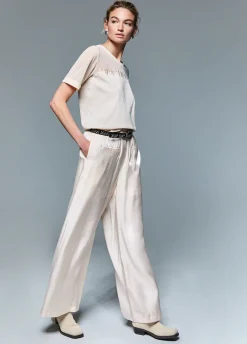Pantaloni flare laminati