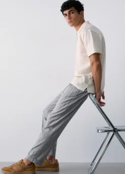 Pantaloni gessati con pence