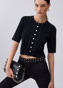 Top in maglia con borchie